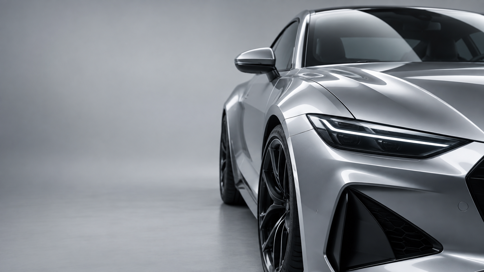 Illustrative silver coupe showing reflections across its paintwork